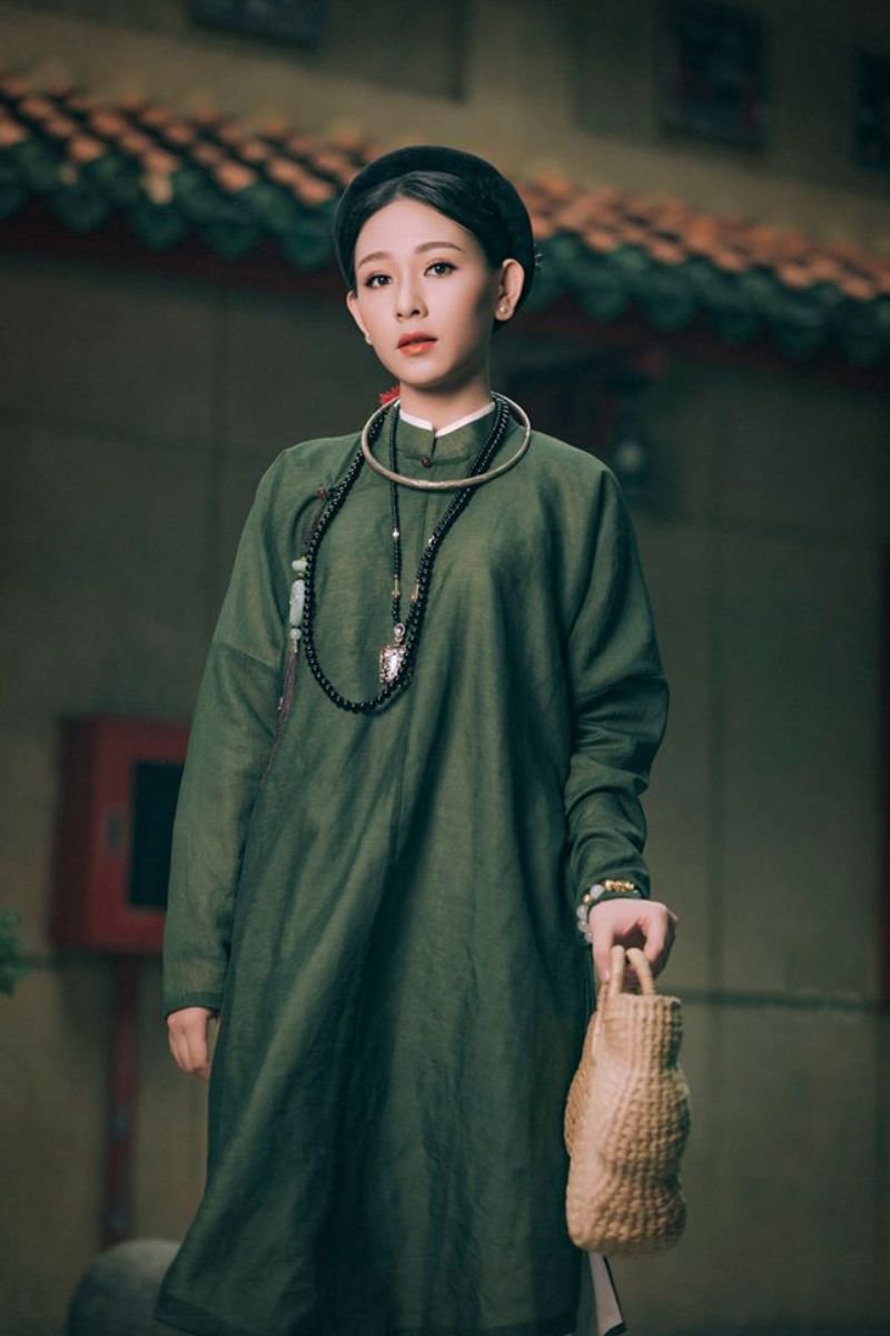 một cô gái mặc áo tấc màu xanh rêu